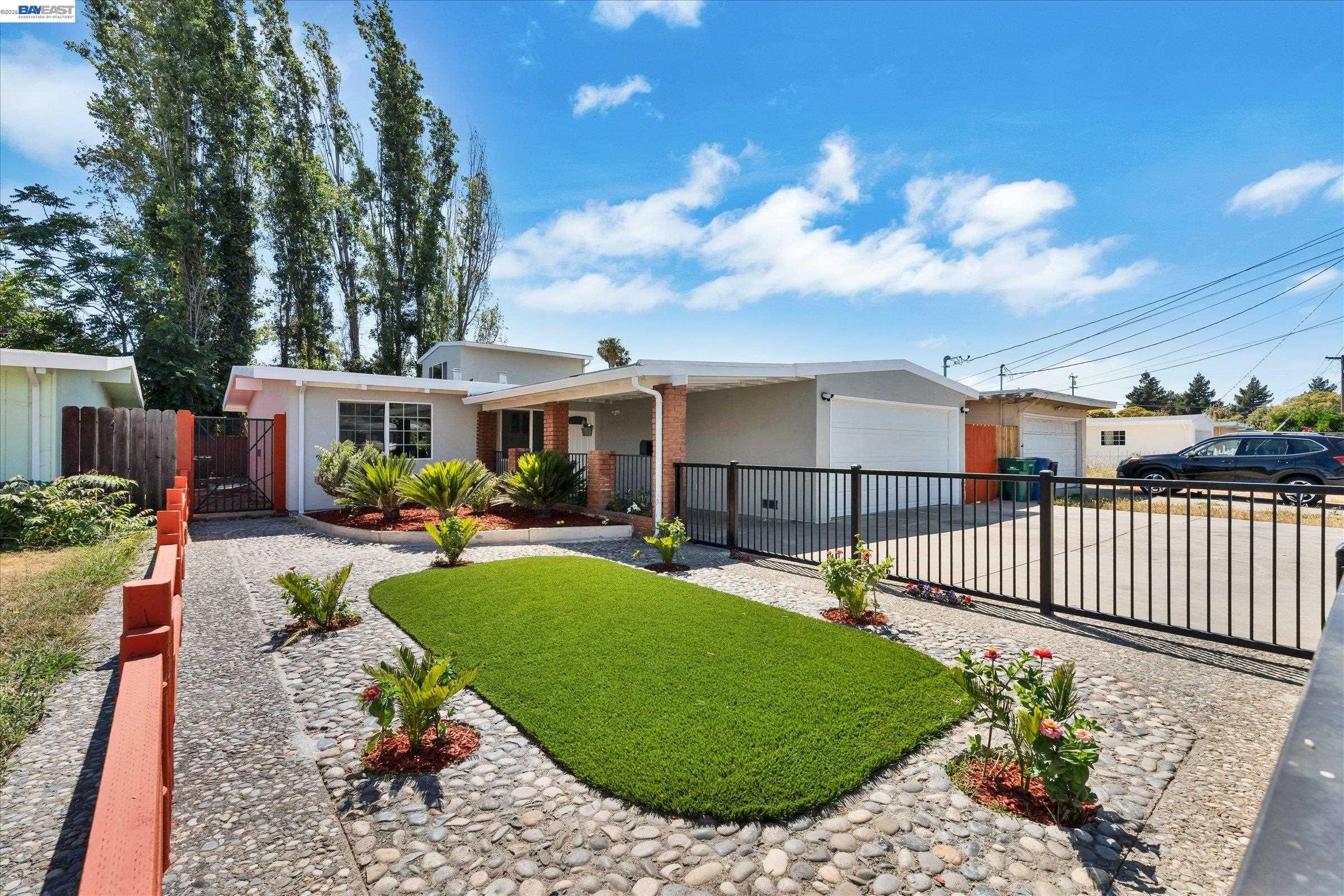 a view of a house with backyard porch and sitting area