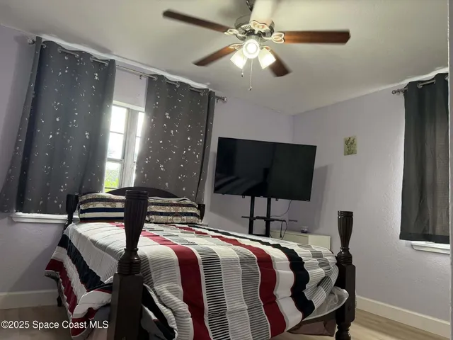 a bedroom with bed and tv