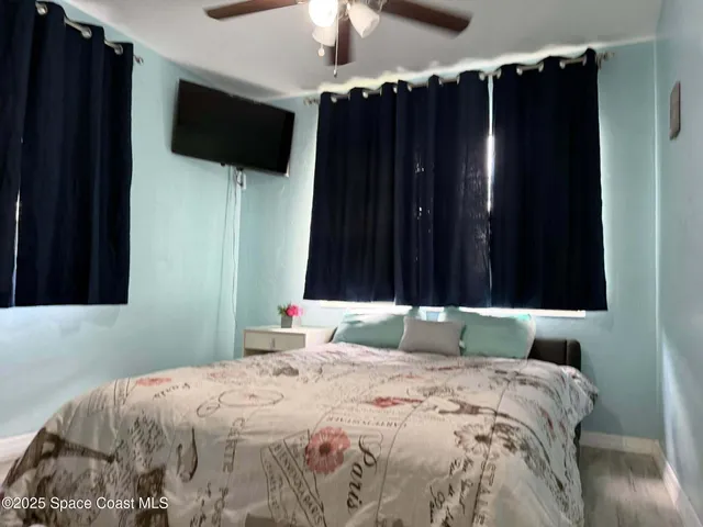 a bedroom with a bed and a flat tv screen