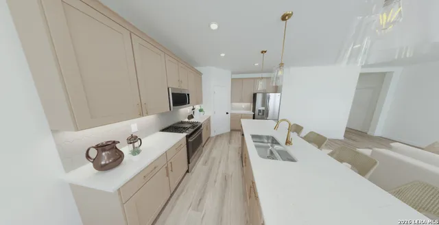 a living room with furniture a flat screen tv and kitchen view