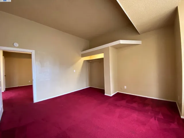 an empty room with closet area