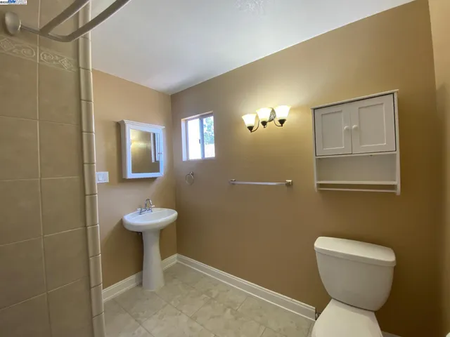 a bathroom with a toilet and shower