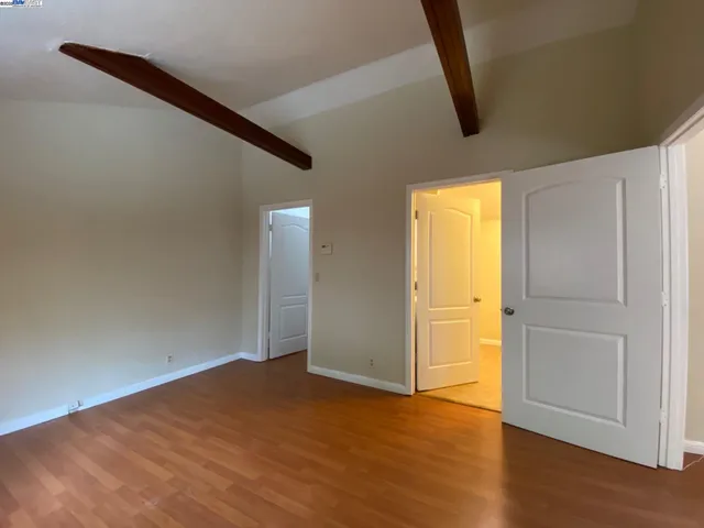 a view of a kitchen with a sink and a refrigerator