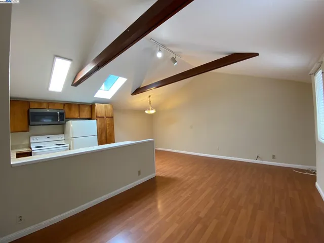 a view of a kitchen with a sink and a refrigerator