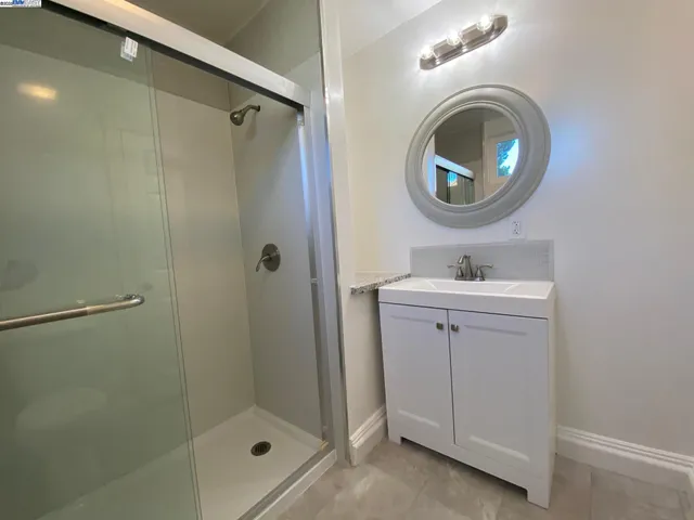 a bathroom with a sink a mirror and a shower