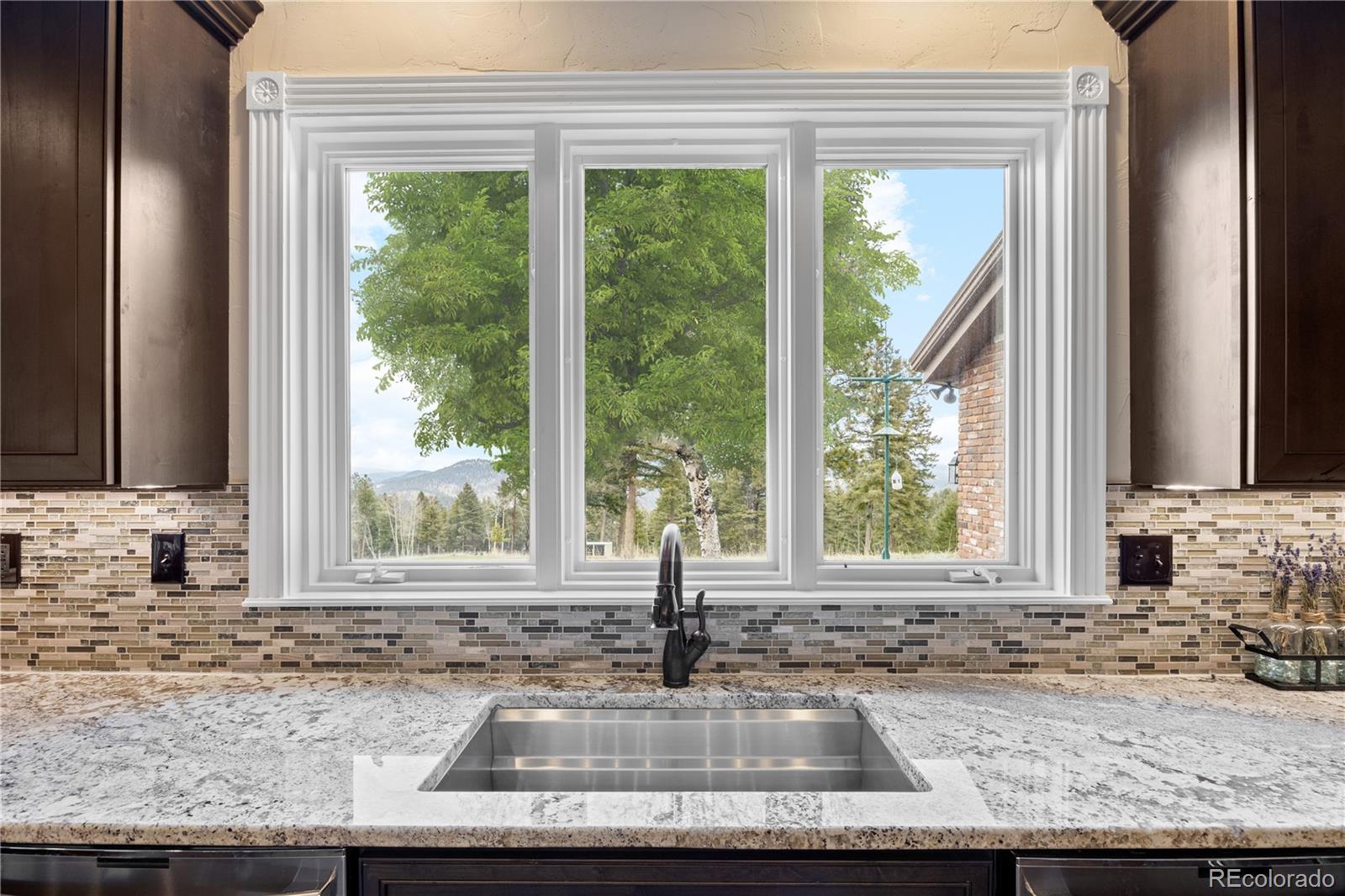 26269 Richmond Hill Road Conifer, CO 80433 - Photo 17 of 44 a kitchen with granite countertop a sink and a window