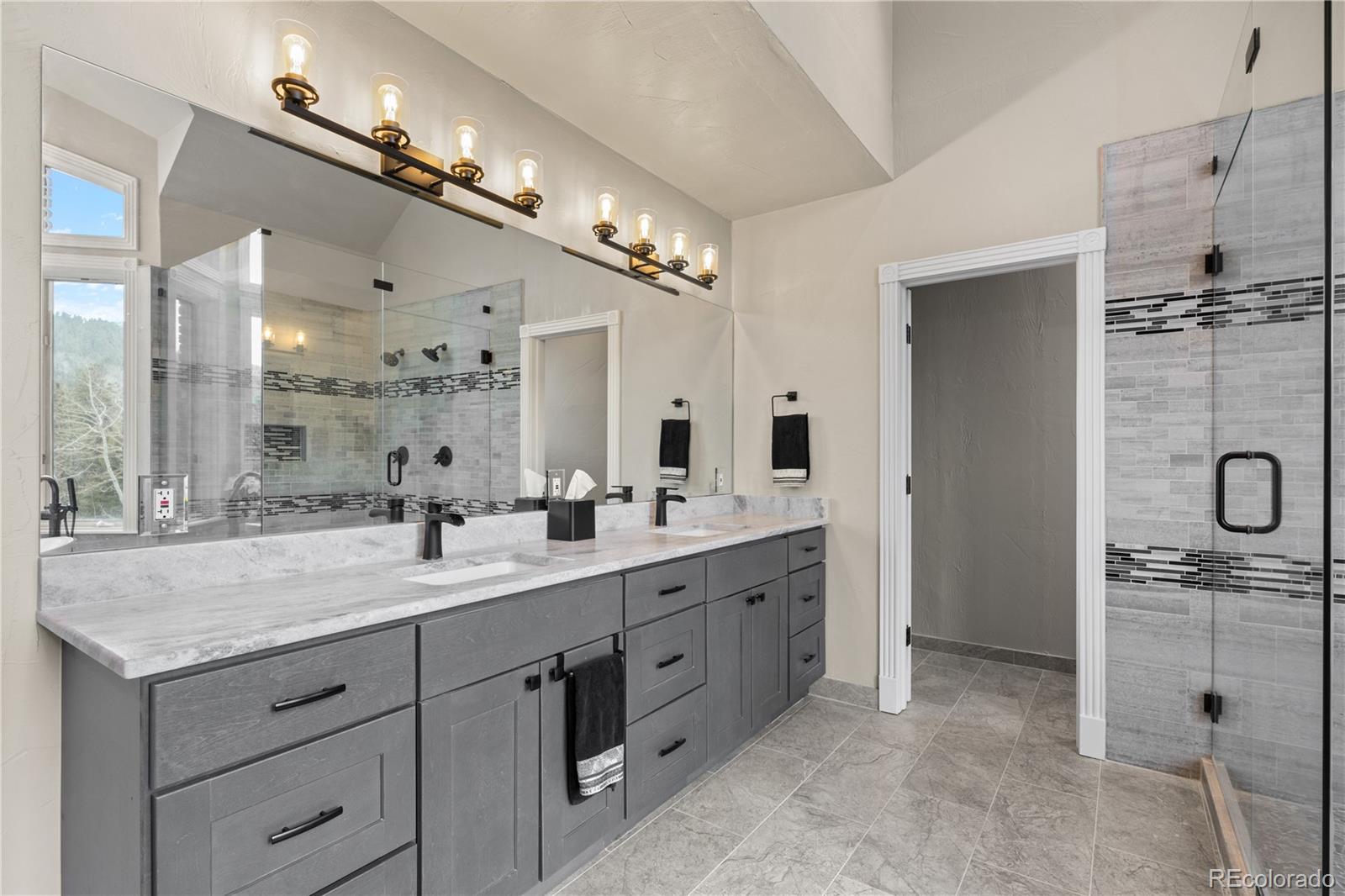 26269 Richmond Hill Road Conifer, CO 80433 - Photo 23 of 44 a bathroom with a granite countertop sink mirror and double