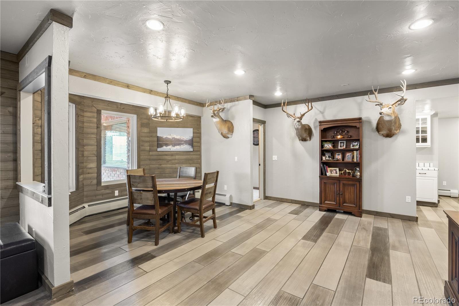 26269 Richmond Hill Road Conifer, CO 80433 - Photo 29 of 44 a view of a dining room with furniture window and wooden floor