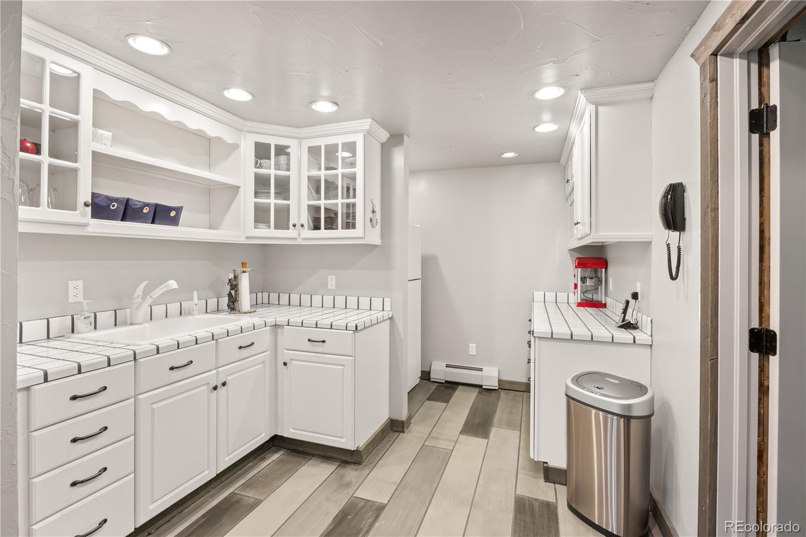 26269 Richmond Hill Road Conifer, CO 80433 - Photo 30 of 44 a bathroom with a sink a washer and dryer