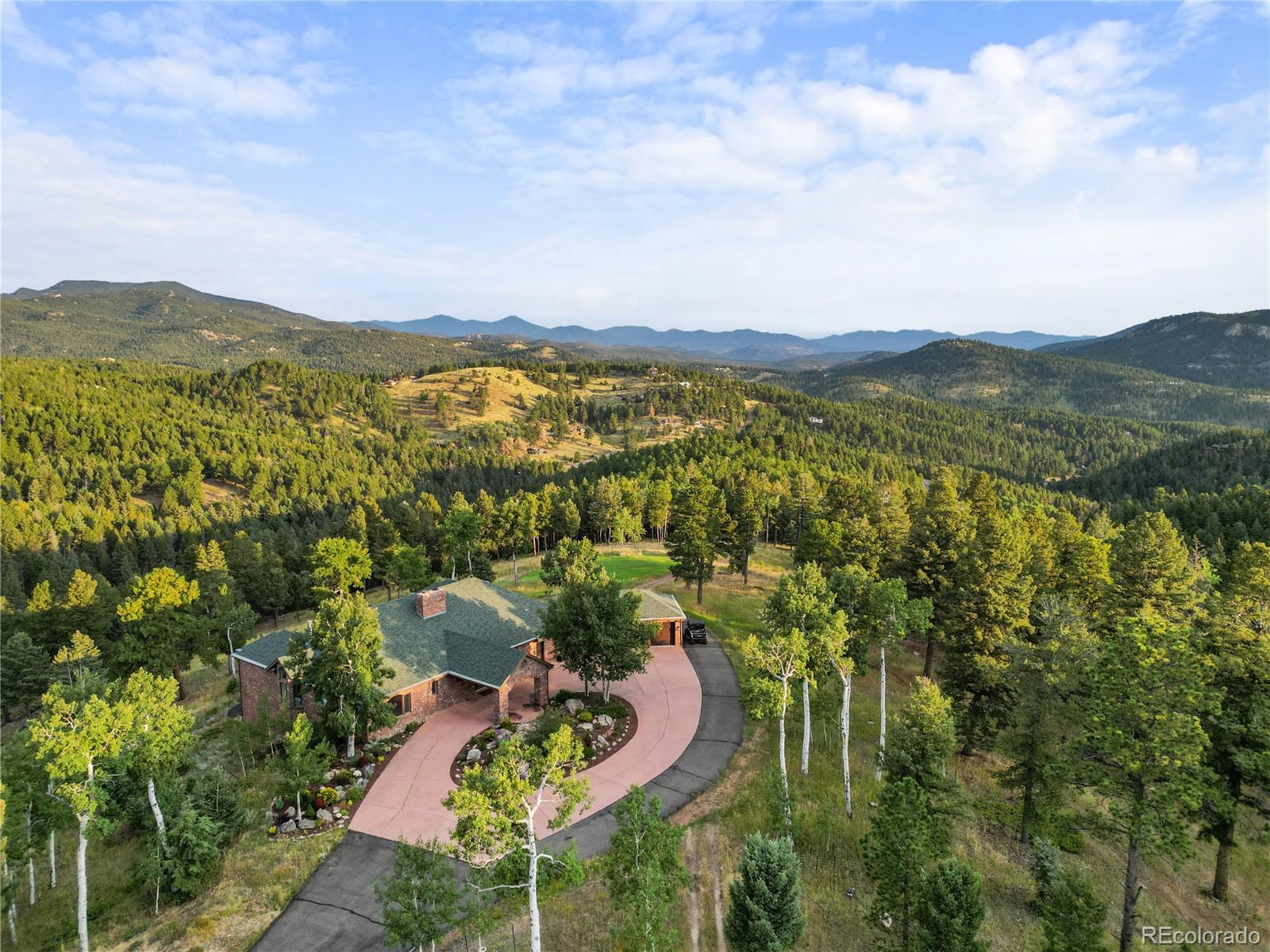 26269 Richmond Hill Road Conifer, CO 80433 - Photo 3 of 44 a view of a city with lush green forest