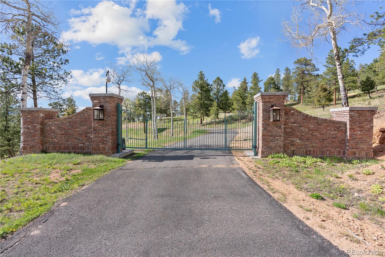 26269 Richmond Hill Road Conifer, CO 80433 - Photo 34 of 44 a view of a road with a house in the background