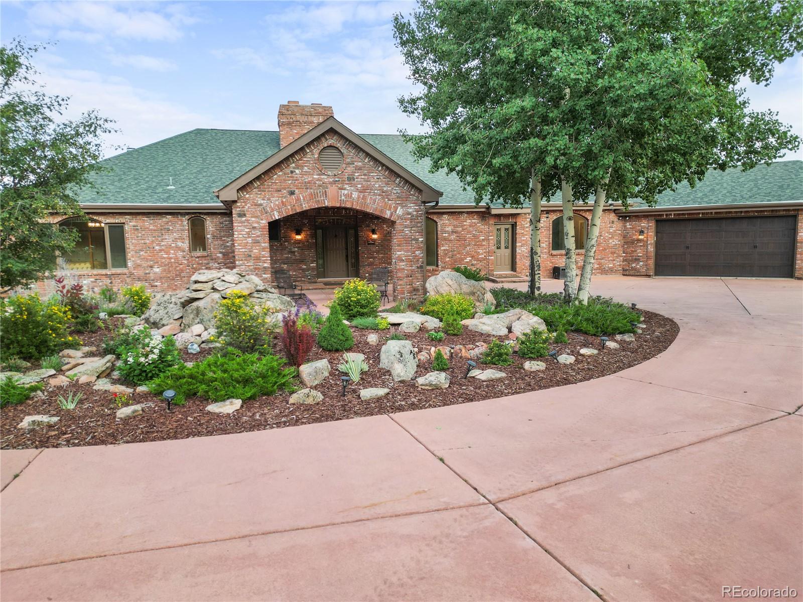 26269 Richmond Hill Road Conifer, CO 80433 - Photo 8 of 44 a front view of a house with a yard