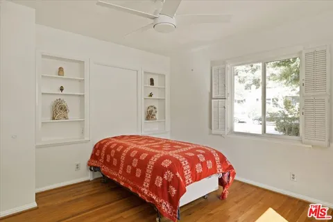 a bedroom with a bed and window