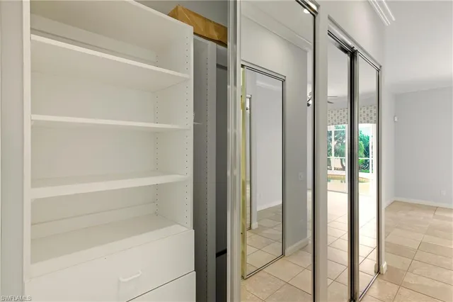 a view of walk in closet with empty racks