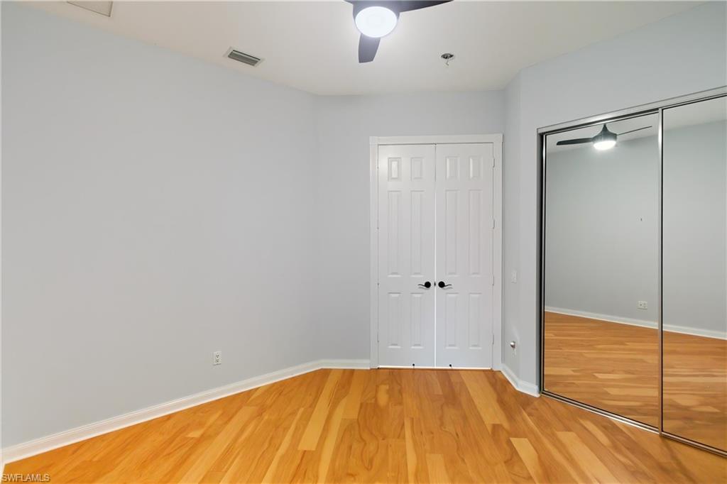7704 Hernando Court Naples, FL 34114 - Photo 27 of 41 a view of a room with wooden floor and fan