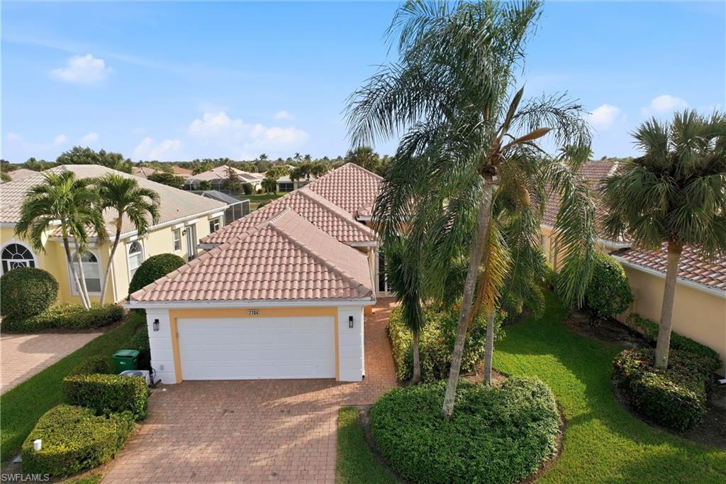 7704 Hernando Court Naples, FL 34114 - Photo 38 of 41 a front view of a house with a garden