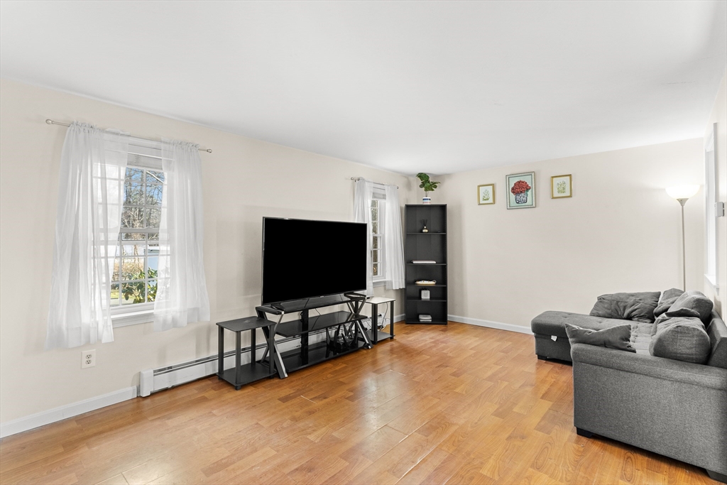5 A Homestead Drive, Unit A Derry, NH 03038 - Photo 11 of 26 a living room with furniture and a flat screen tv