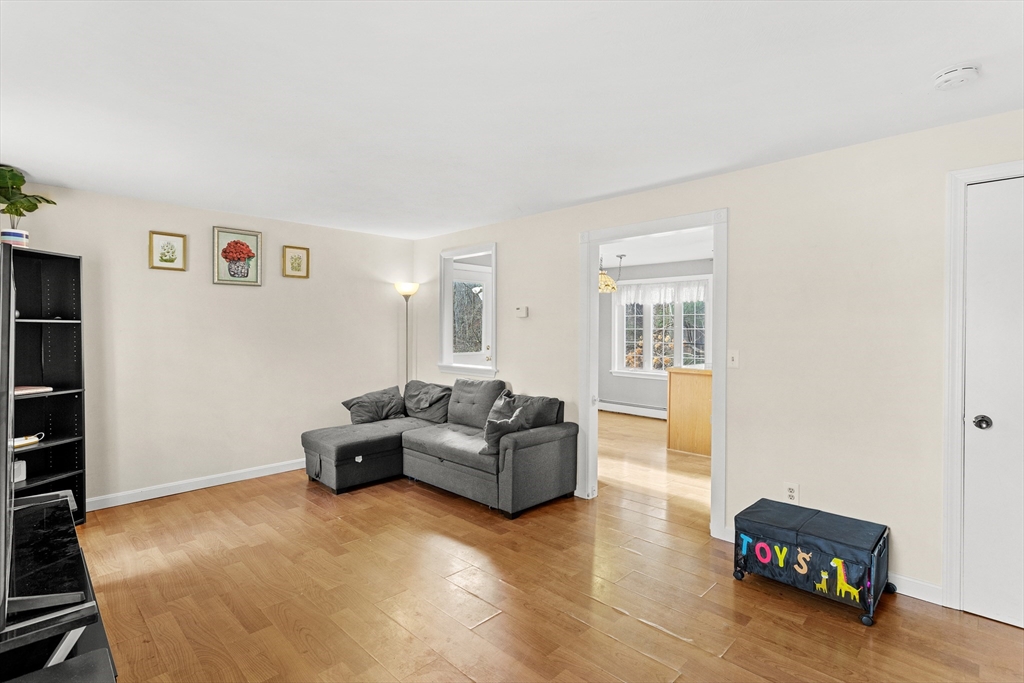 5 A Homestead Drive, Unit A Derry, NH 03038 - Photo 12 of 26 a living room with furniture and a flat screen tv