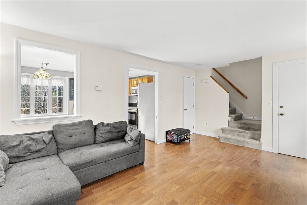5 A Homestead Drive, Unit A Derry, NH 03038 - Photo 13 of 26 a living room with furniture and a window