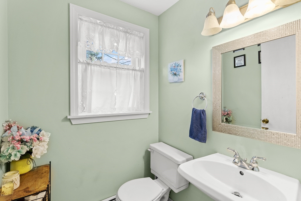 5 A Homestead Drive, Unit A Derry, NH 03038 - Photo 14 of 26 a bathroom with a sink mirror and toilet