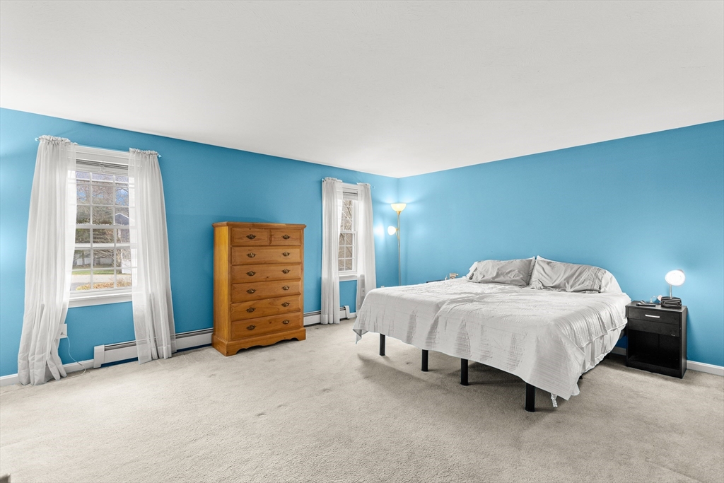 5 A Homestead Drive, Unit A Derry, NH 03038 - Photo 15 of 26 a bedroom with a bed and a walk in closet