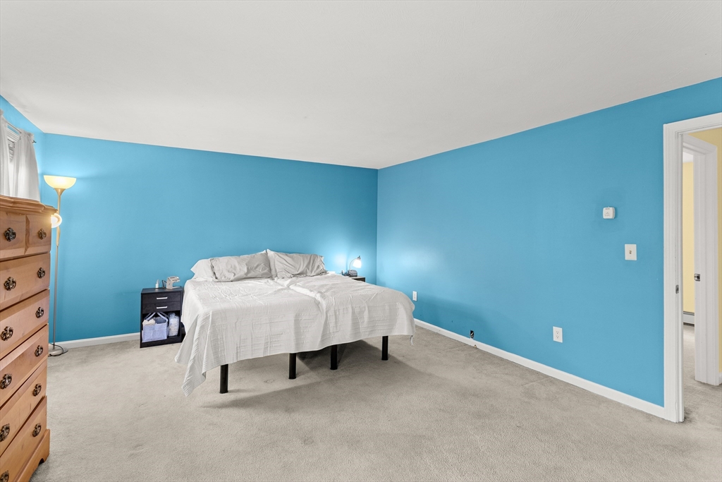 5 A Homestead Drive, Unit A Derry, NH 03038 - Photo 16 of 26 a bed room with a bed and a lamp