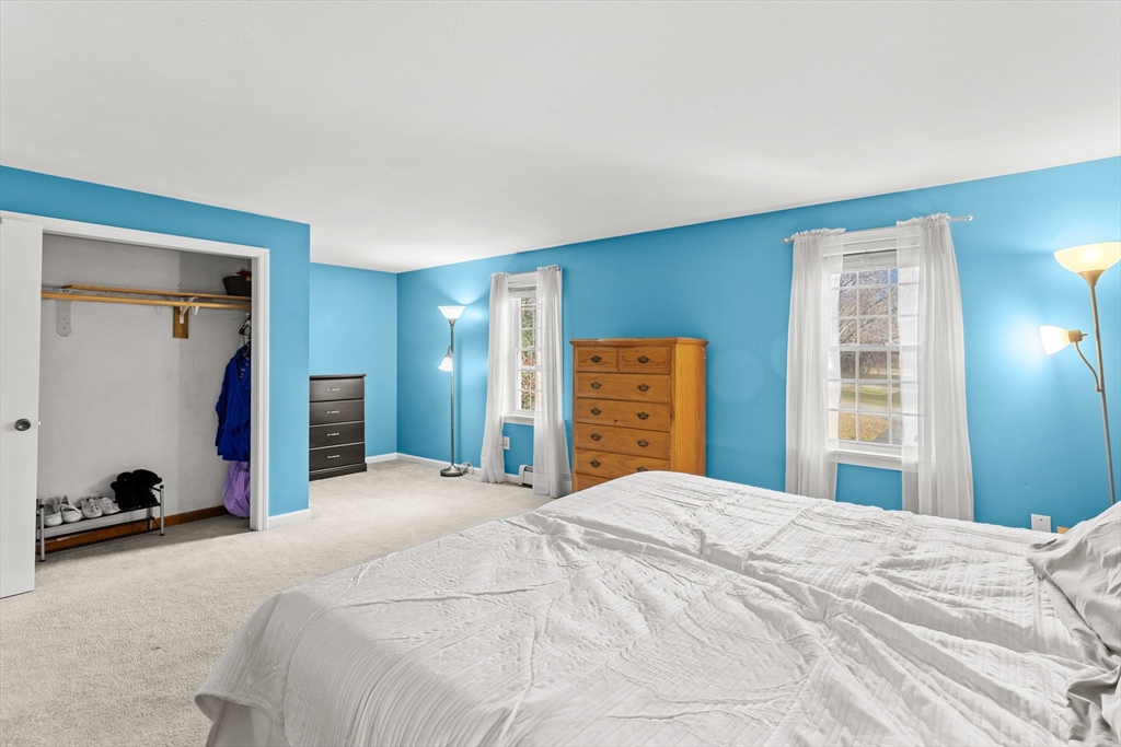 5 A Homestead Drive, Unit A Derry, NH 03038 - Photo 18 of 26 a bedroom with a bed and a large window