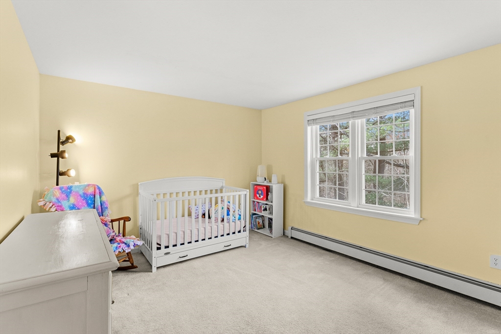 5 A Homestead Drive, Unit A Derry, NH 03038 - Photo 19 of 26 a bedroom with a bed and a window