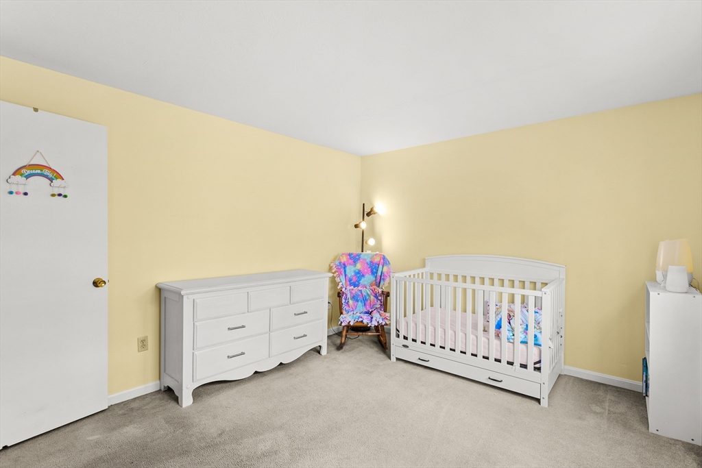 5 A Homestead Drive, Unit A Derry, NH 03038 - Photo 20 of 26 a bedroom with a bed and a window