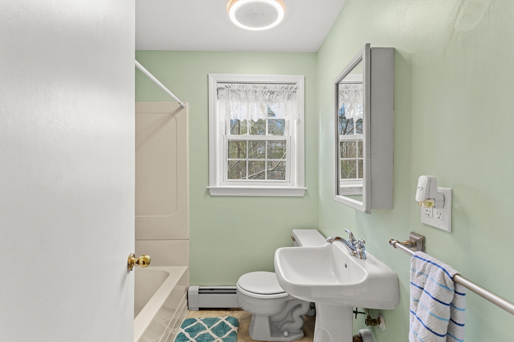 5 A Homestead Drive, Unit A Derry, NH 03038 - Photo 22 of 26 a bathroom with a sink toilet and mirror