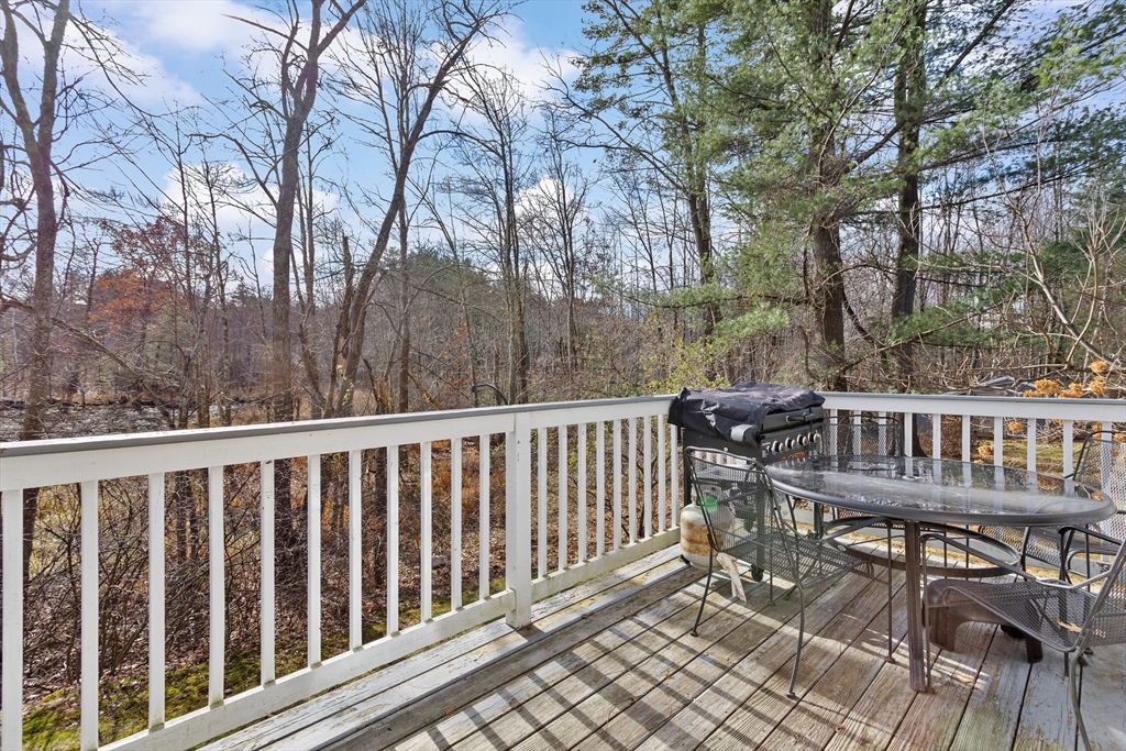 5 A Homestead Drive, Unit A Derry, NH 03038 - Photo 23 of 26 a view of balcony with wooden floor and fence