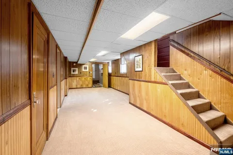 a view of hallway with wooden walls
