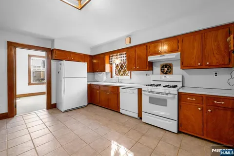 a kitchen with a stove a sink and a refrigerator
