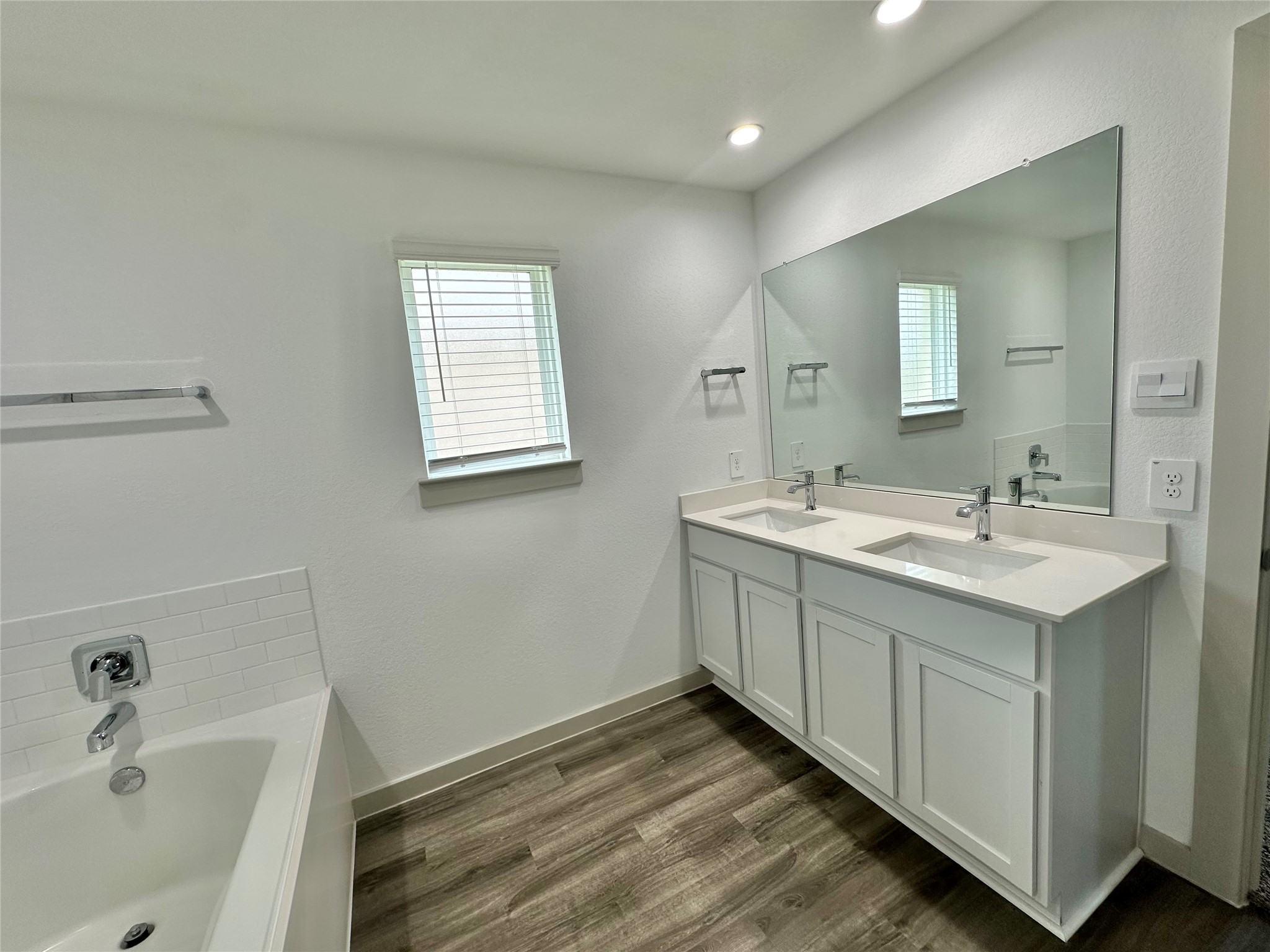 1107 Curly Angora Court Rosharon, TX 77583 - Photo 34 of 42 a bathroom with a double vanity sink and a bathtub
