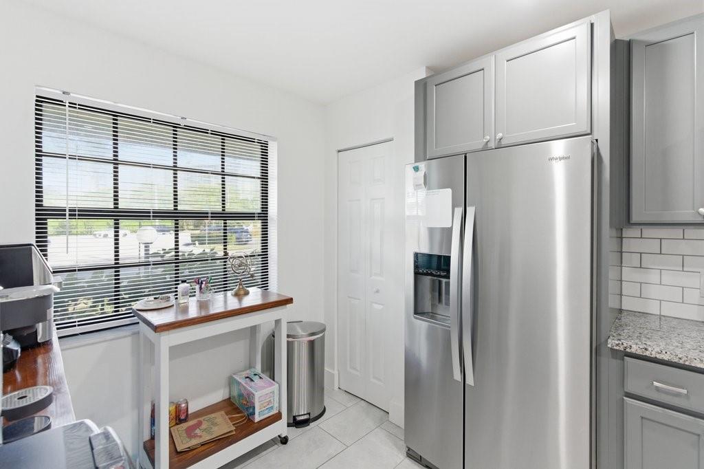 10900 West Sample Road Coral Springs, FL 33065 - Photo 15 of 32 a kitchen with stainless steel appliances a refrigerator and a sink
