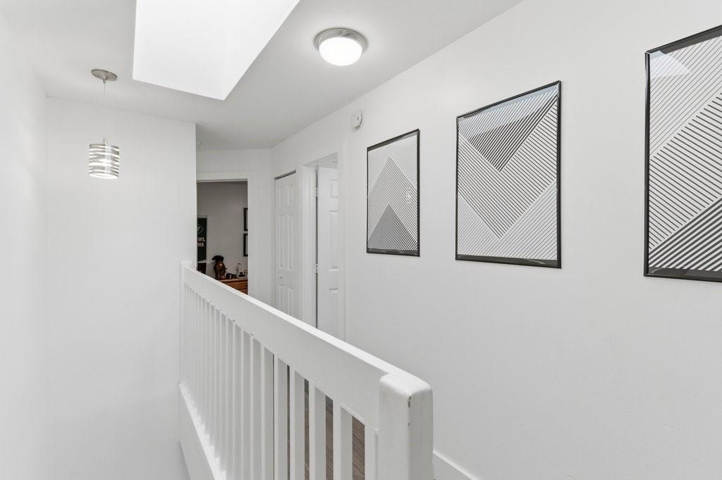 10900 West Sample Road Coral Springs, FL 33065 - Photo 16 of 32 a view of a hallway with paintings on the wall