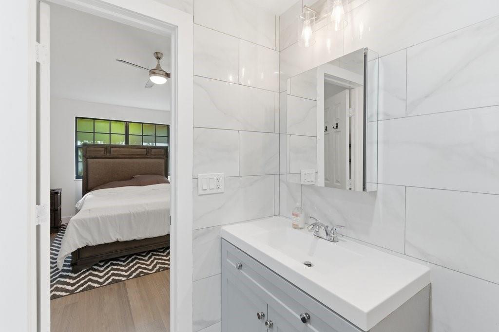 10900 West Sample Road Coral Springs, FL 33065 - Photo 18 of 32 a bathroom with a sink a toilet and shower