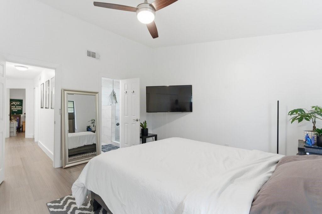 10900 West Sample Road Coral Springs, FL 33065 - Photo 21 of 32 a bedroom with a bed and a flat screen tv