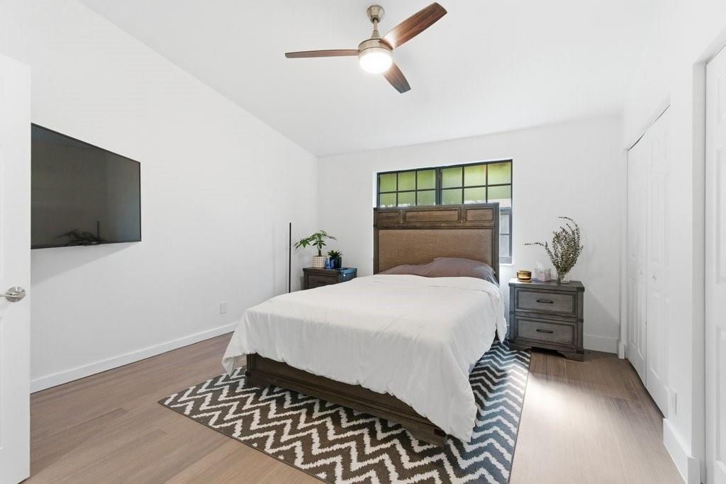 10900 West Sample Road Coral Springs, FL 33065 - Photo 22 of 32 a bedroom with a bed and a flat screen tv