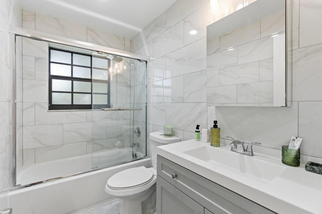 10900 West Sample Road Coral Springs, FL 33065 - Photo 23 of 32 a bathroom with a sink a toilet and shower