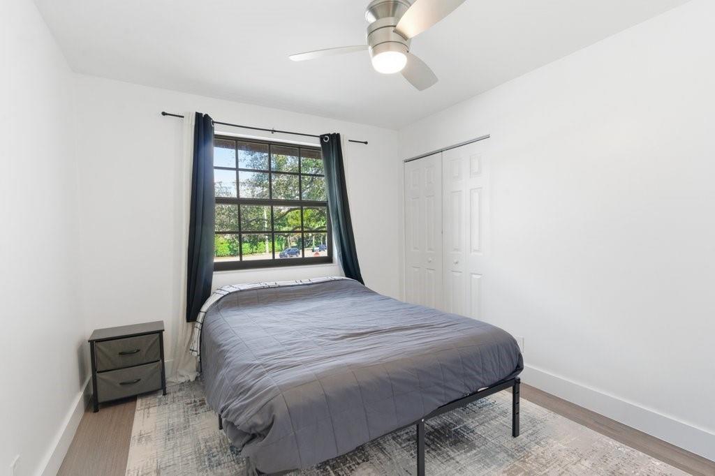 10900 West Sample Road Coral Springs, FL 33065 - Photo 26 of 32 a bedroom with a bed and a window