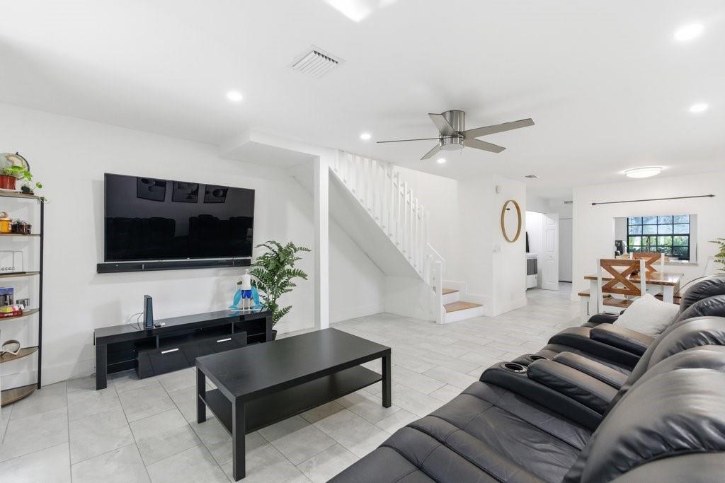 10900 West Sample Road Coral Springs, FL 33065 - Photo 3 of 32 a living room with furniture and a flat screen tv
