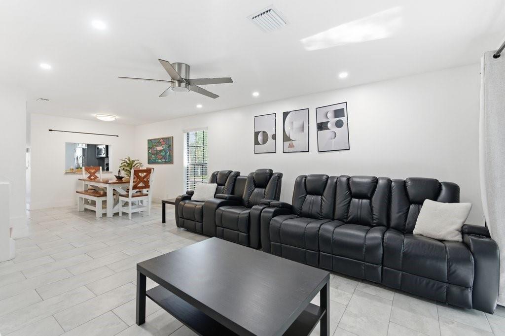 10900 West Sample Road Coral Springs, FL 33065 - Photo 8 of 32 a living room with furniture and kitchen view