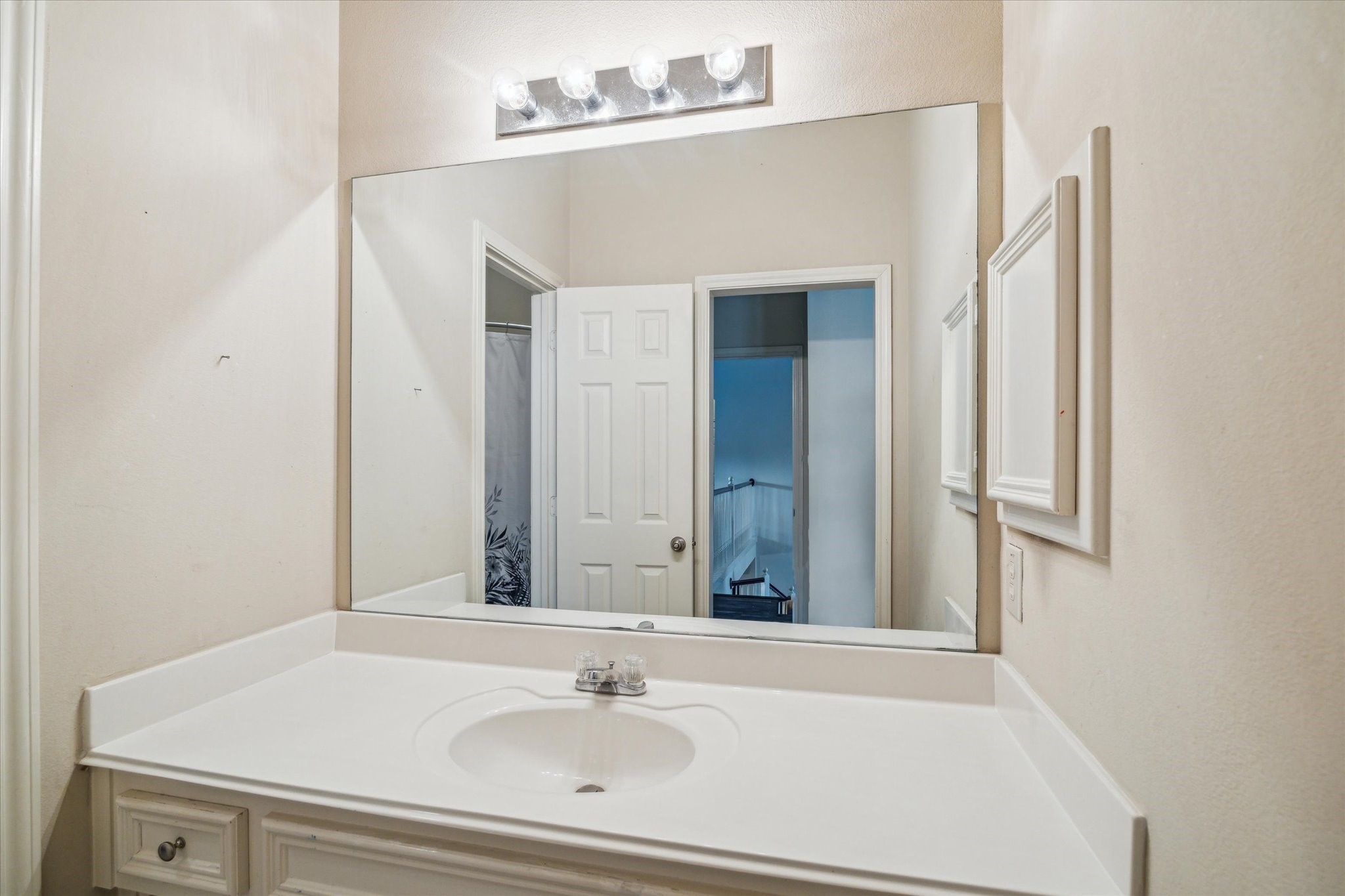15907 Chart House Court Houston, TX 77044 - Photo 22 of 28 a bathroom with a sink and a mirror