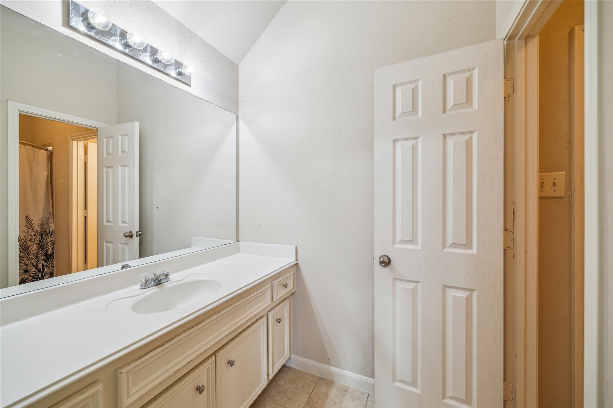 15907 Chart House Court Houston, TX 77044 - Photo 23 of 28 a bathroom with a double vanity sink and a mirror