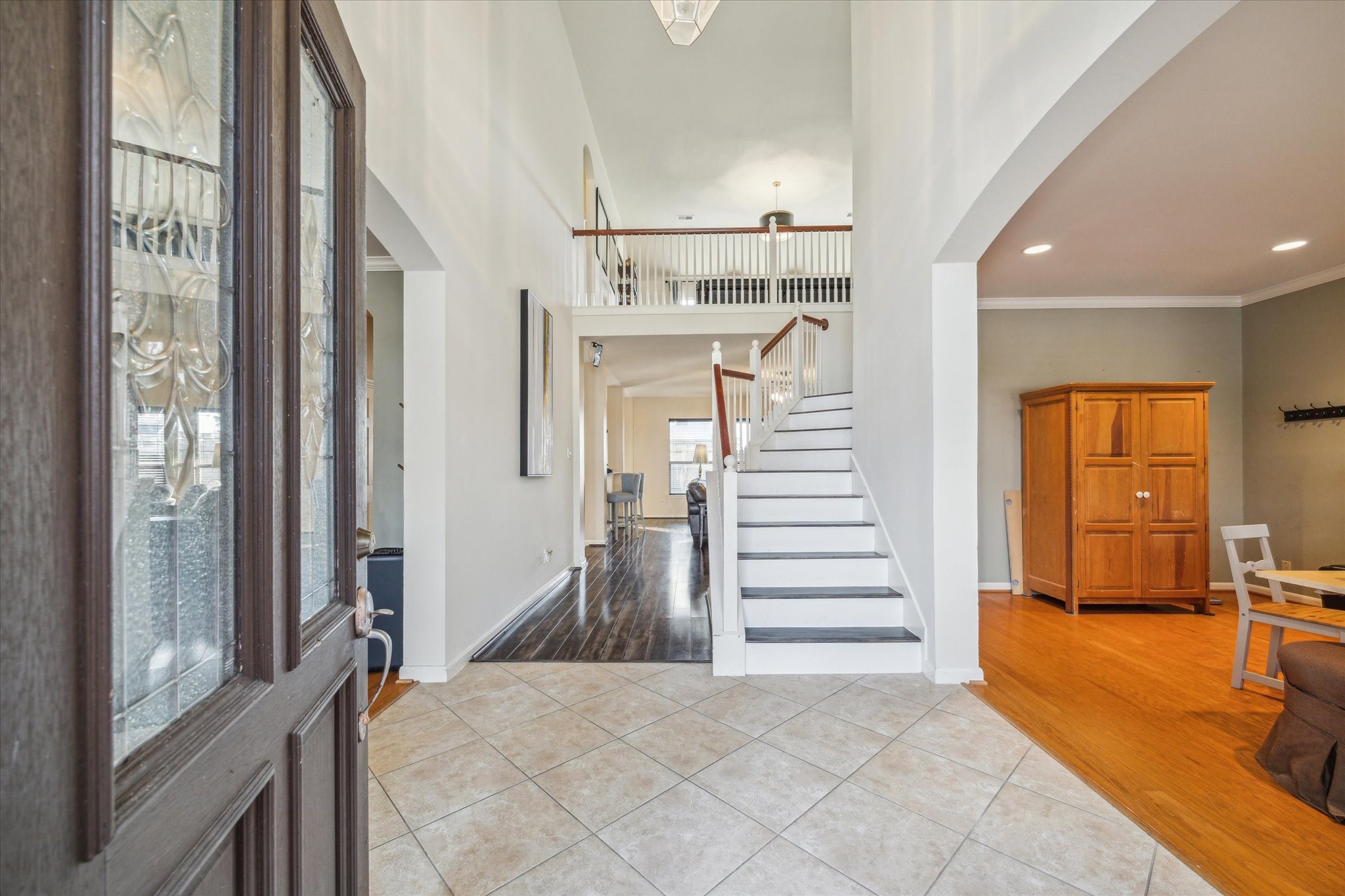 15907 Chart House Court Houston, TX 77044 - Photo 3 of 28 a view of a hallway view with three large windows and a chandelier