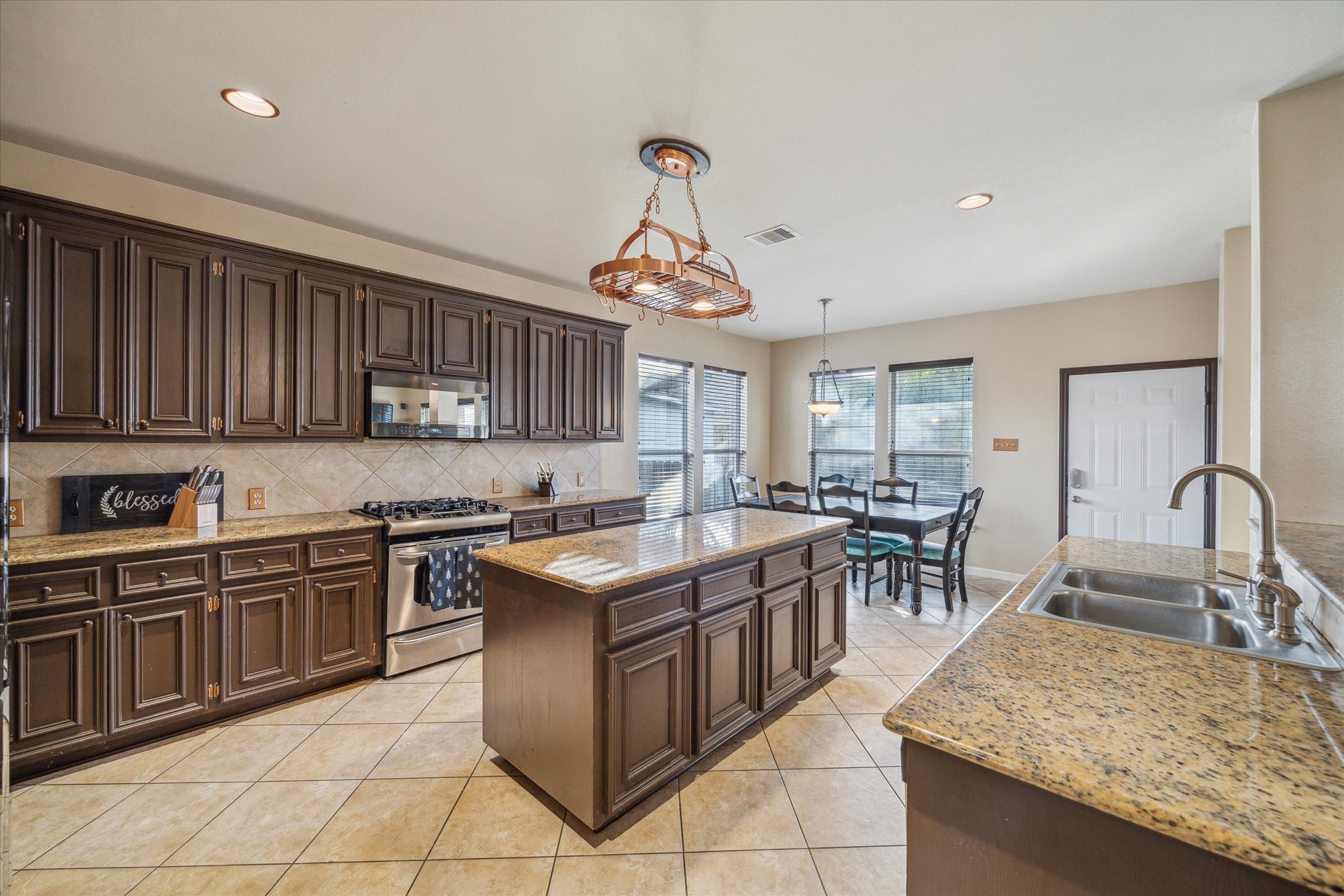 15907 Chart House Court Houston, TX 77044 - Photo 10 of 28 a kitchen with a stove top oven sink and cabinets