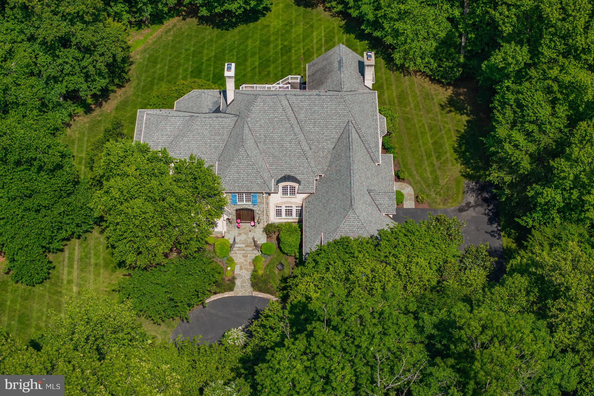 601 Utterback Store Road Great Falls, VA 22066 - Photo 2 of 5 an aerial view of a house with a yard and trees all around