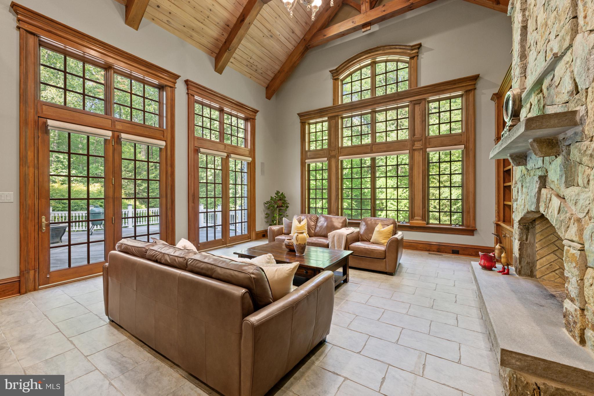601 Utterback Store Road Great Falls, VA 22066 - Photo 5 of 5 a living room with furniture and floor to ceiling windows