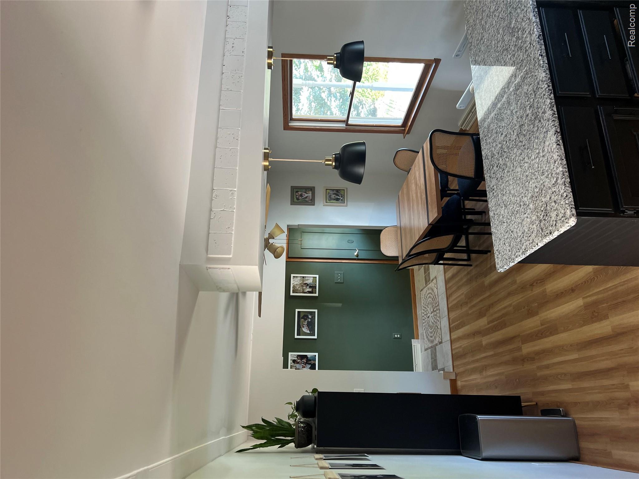 5417 North Road North Street, MI 48049 - Photo 6 of 30 Dining area featuring wood-finish flooring and a wood window frame